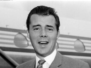 A black and white photo of Dirk Bogarde