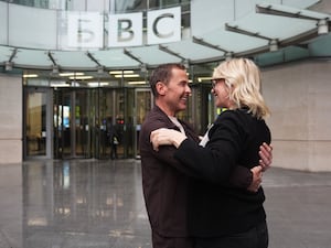 Zoe Ball and Scott Mills embracing outside BBC building