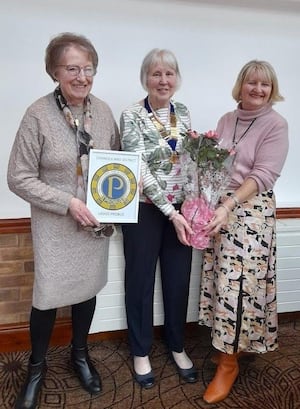 Chris Ballett incoming Vice Chair, Anne Bumford Chairman of Cannock and District Ladies Probus Club, receiving flowers as appreciation, from Jill Gooch Treasurer (L to R)