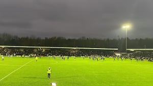 Some Hednesford Town supporters run onto the Keys Park surface towards some Gainsborough Trinity fans who are also on the pitch