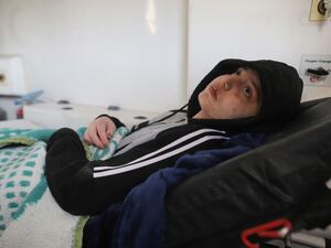 A Palestinian girl wounded in the Israeli bombardment of the Gaza Strip waits inside an ambulance