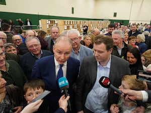 Fianna Fail party leader Micheal Martin, stands with Padraig O’Sullivan (Jacob King/PA)