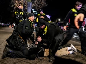 German police officers detaining a man