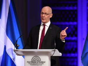 First Minister John Swinney delivers a speech