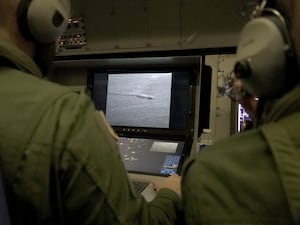 Crew members aboard a French Navy Atlantique 2 surveillance plane patrolling over the Baltic Sea to protect undersea cables and pipelines from sabotage