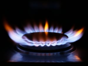 A lit gas ring on a hob