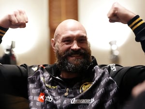 Tyson Fury raises his arms in a show of strength