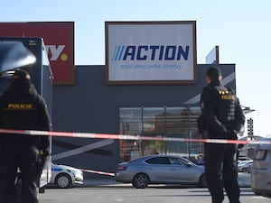 Police officers stand guard in a shopping area in Hradec Kralove, Czech Republic