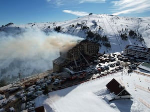 Firefighters work to extinguish a fire in a hotel