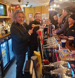 Rock legend Robert Plant behind the bar at The Leaping Wolf. 