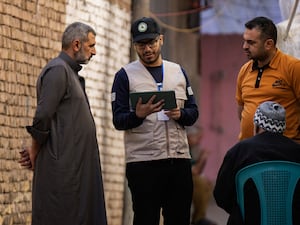 A worker prepares to collect information from the public