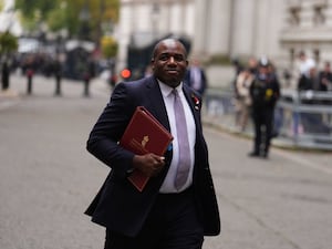 David Lammy leaves Downing Street after a Cabinet meeting, carrying a red ministerial folder under his arm