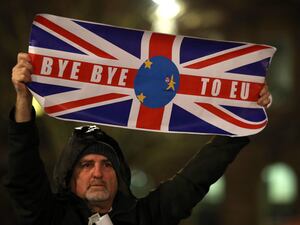 A pro-Brexit protester waves a banner with the words "Bye bye to EU" written on a Union Jack on the night Britain left the EU in 2020