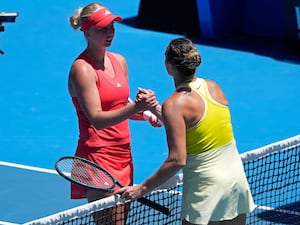 Aryna Sabalenka, right, shakes hands with Clara Tauson