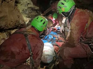 Ottavia Piana, a caver blocked in a deep inside the Bueno Fonteno cave, is carried to safety by rescue workers after falling some five meters during an expedition