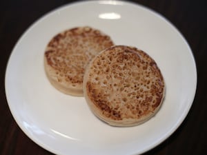 Unbuttered crumpets on a plate