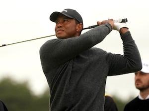 Tiger Woods tees off