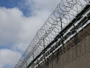 Razor wire on top of a prison wall