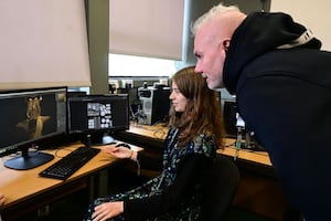 Gaming student Stephanie Thompson shows her work to Trev Keane, co-founder and managing director at Feenix Group