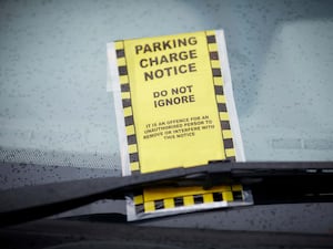 A parking charge notice on a car windscreen