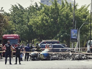 Police cordon off the street where a small aircraft crashed in Sao Paulo