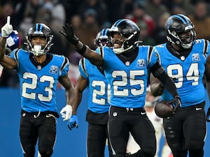 Carolina Panthers safety Xavier Woods celebrates after intercepting a pass against the New York Giants during the first half of an NFL football game in Munich