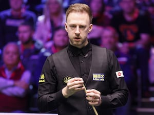 Judd Trump chalks his cue during his win over Kyren Wilson