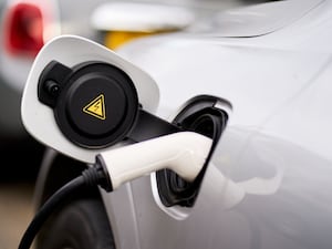 An electric car plugged into an EV charging point in central London