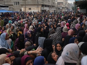 Palestinians gather to get food at a distribution centre in Deir al-Balah, Gaza Strip