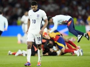 England’s Jude Bellingham appears dejected after the final whistle in the UEFA Euro 2024 final as Spain celebrate in the background