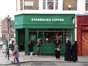 People wait outside Starbucks (Kirsty O'Connor/PA)