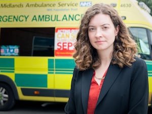 Sarah Coombes MP standing in-front of an ambulance.