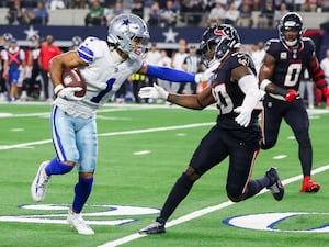 Dallas Cowboys wide receiver Jalen Tolbert, left, puts a stiff arm on Houston Texans safety Jimmie Ward