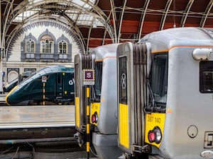 A Great Western Railway train and two Heathrow Express trains at Paddington station