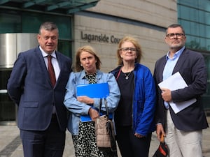 Solicitor Niall Murphy, with clients Caoimhe Hanna and Roisin Ni Dhonaill, the sisters of victim Kevin Barry O’Donnell who was killed during the Clonoe Ambush, and Relatives for Justice CEO Mark Thompson, leaving Laganside Court, Belfast.