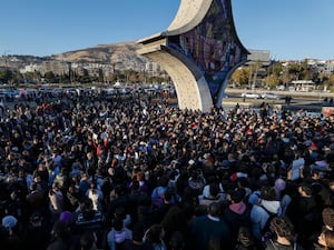 Syrian activists gather at the Umayyad square during a protest to demand a secular state, in Damascus on Thursday