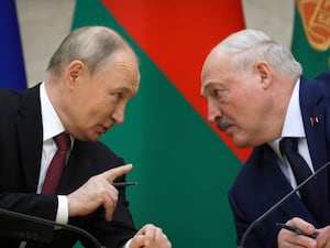 Russian President Vladimir Putin, left, and Belarusian President Alexander Lukashenko talk during a signing ceremony in Minsk, Belarus