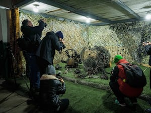 Journalists view fragments of what authorities in Kyiv described as a Russian hypersonic missile that struck a factory in Dnipro