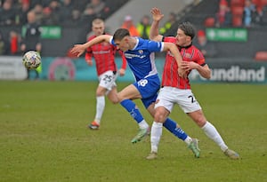 Jamie Jellis challenges for the ball.