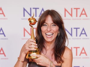 Davina McCall holds up an award