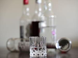 Alcohol bottles and a glass on a table