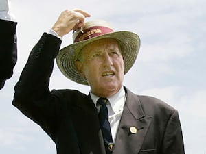 Neale Fraser touches his hat to acknowledge the crowds during celebrations for the 50th anniversary of the Tennis Hall of Fame in Newport, R.I. on July 10, 2004