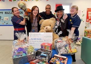 Halloween Queen Surinder Mann, with husband Suky Mann, hand over money raised from fundraising events to the Children's Ward at New Cross Hospital.