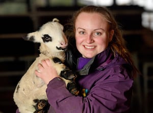 Lliwen Williams, a placement student from Harper Adams University, with Jan the lamb at the farm