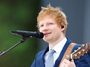 Ed Sheeran performing with a guitar