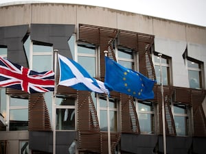 A union flag, saltire and EU flag fly side by side