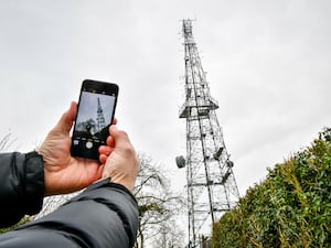 A phone taking a photo of a phone mast