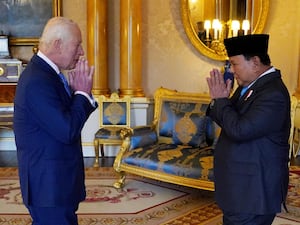 The King and President Prabowo Subianto make the traditional gesture of greeting