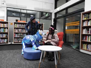 Pearl Ogunyadeka, 10, reading a book inside Spellow Community Hub and Library in Walton, as it reopens