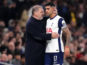 Tottenham manager Ange Postecoglou (left) speaks with Cristian Romero after his substitution